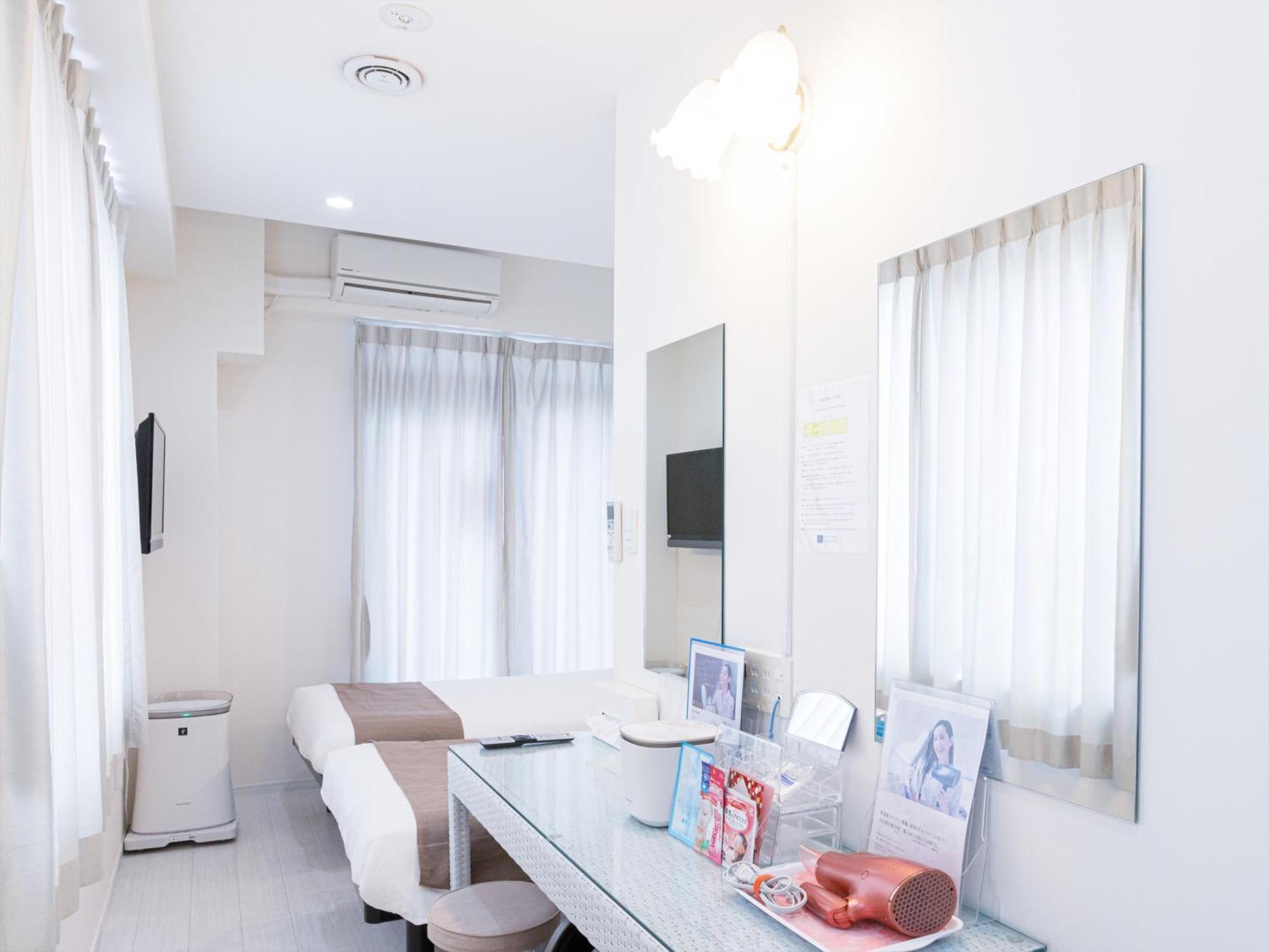かりゆしコンドミニアムリゾート那覇スカイリビングホテル旭橋駅前 Naha Zimmer foto